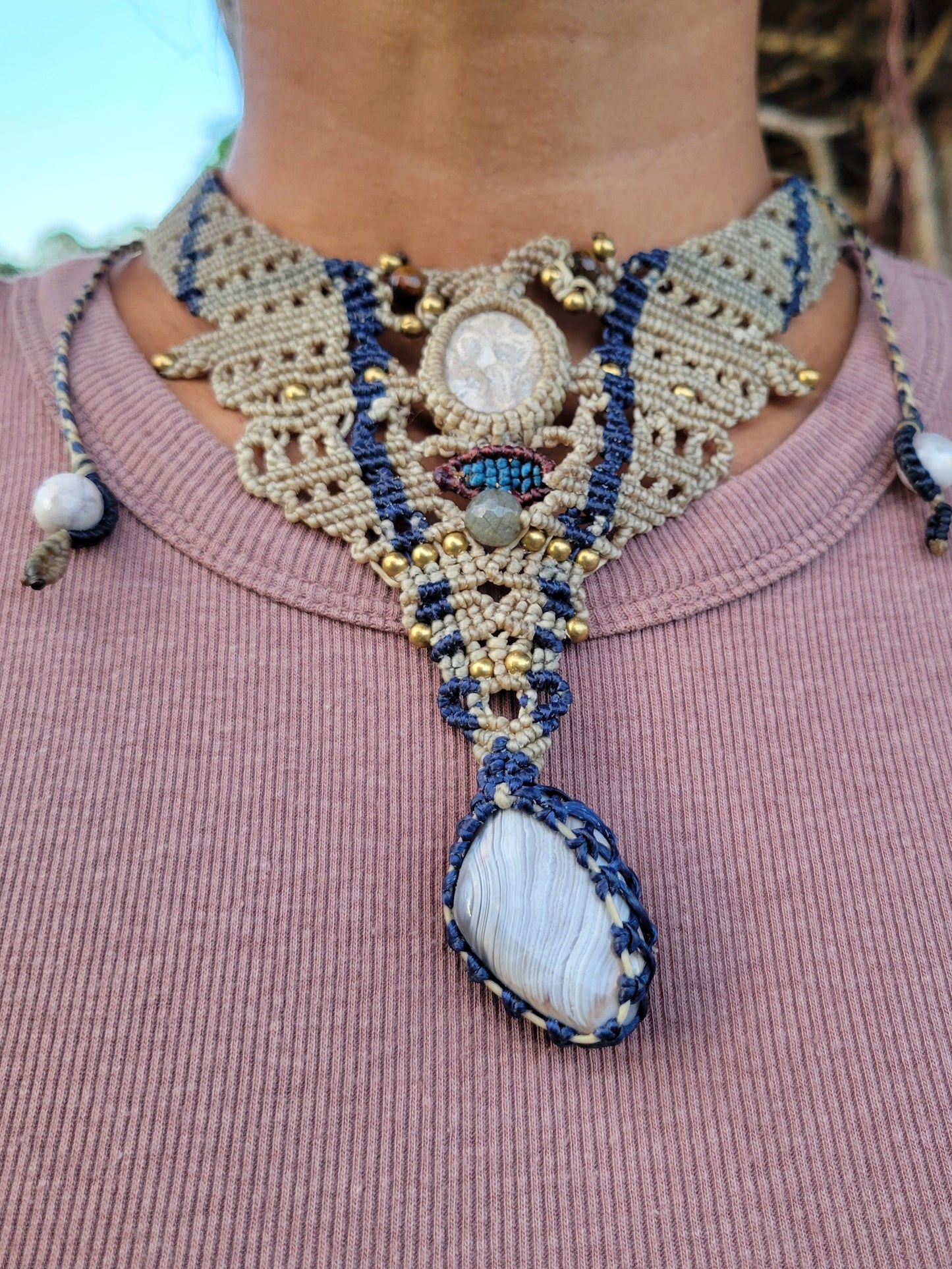 Ocean Jewelry choker featuring fossil ammonite, agate, and micromacramé design in beige and blue.