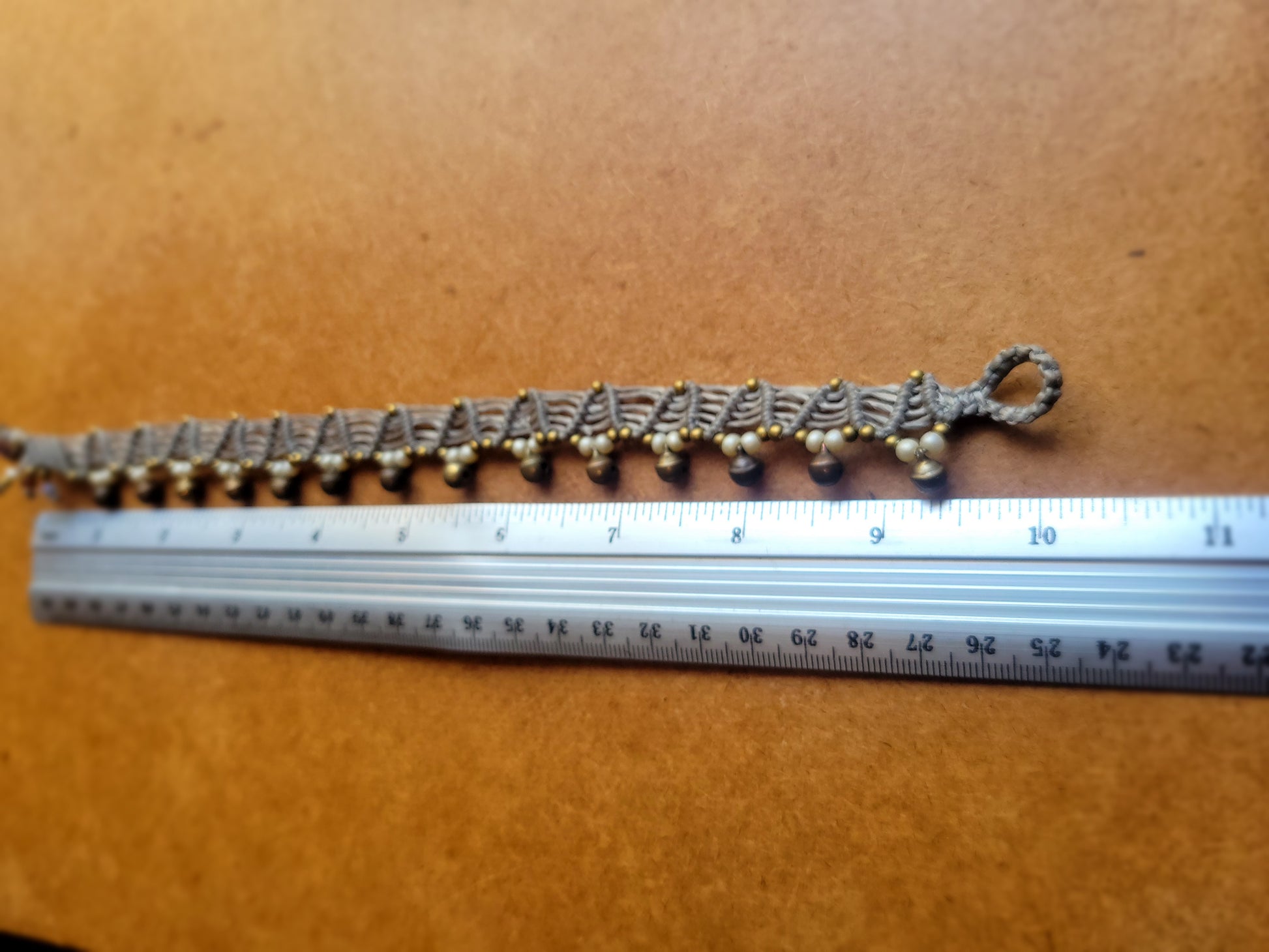 Boho Anklets – Brass Bell Macramé Hippie Anklet with measurement scale, showcasing intricate crochet design and resilient materials.