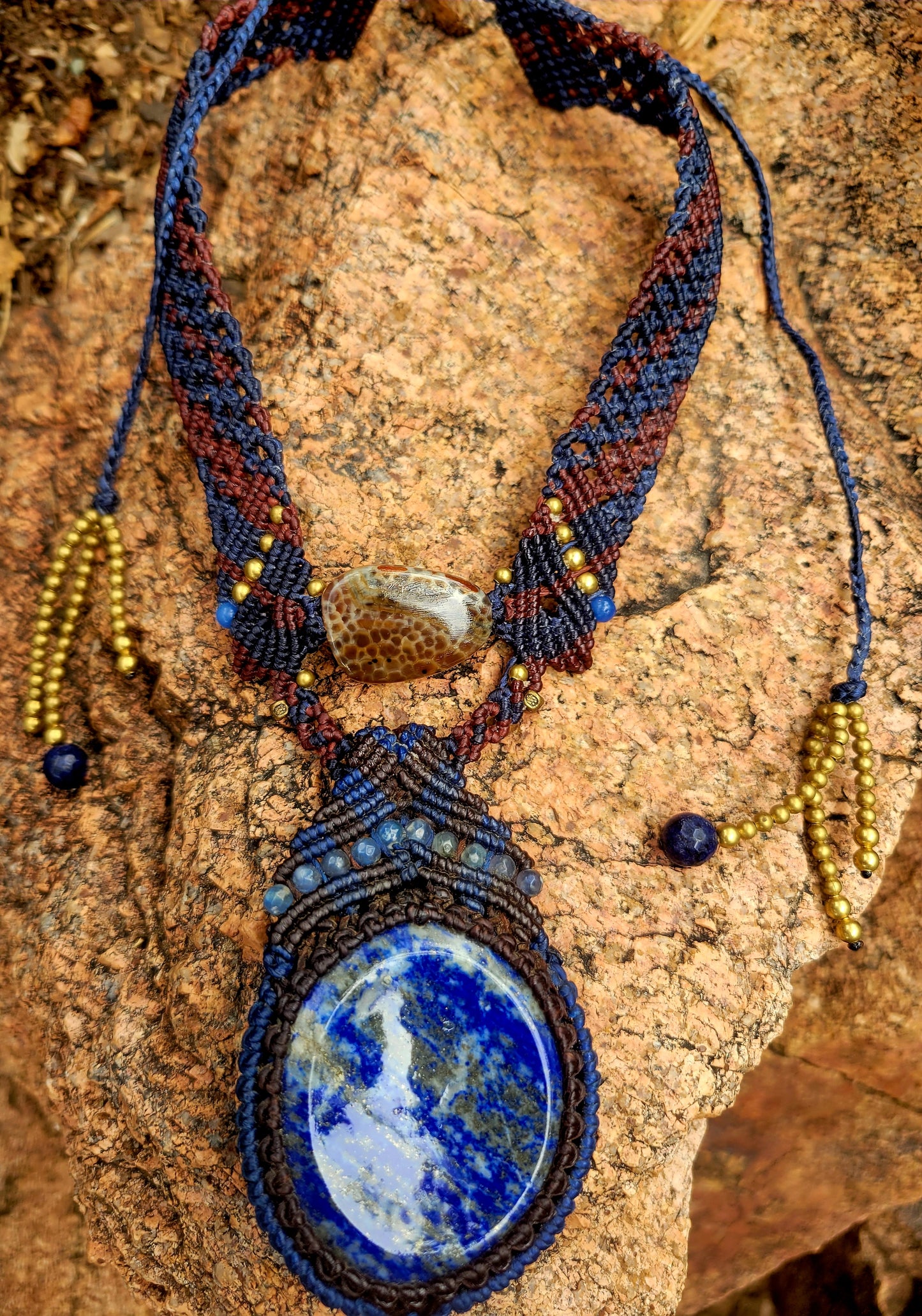 Lapis Lazuli Necklace featuring large oval pendant and intricate micromacramé collar, accented with blue stone beads.