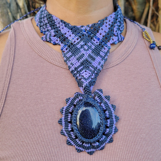 Handmade Boho Necklace featuring a blue sandstone pendant in intricate macramé knotwork with purple tones.