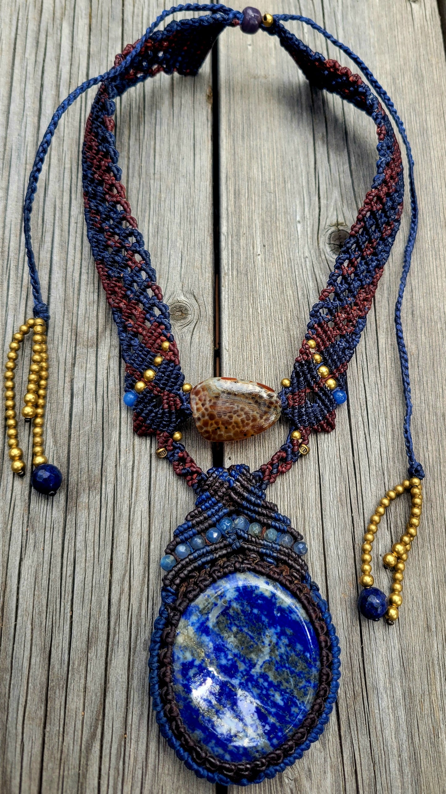 Lapis Lazuli Necklace featuring large blue pendant, Crab Agate, and dark brown micromacramé design.