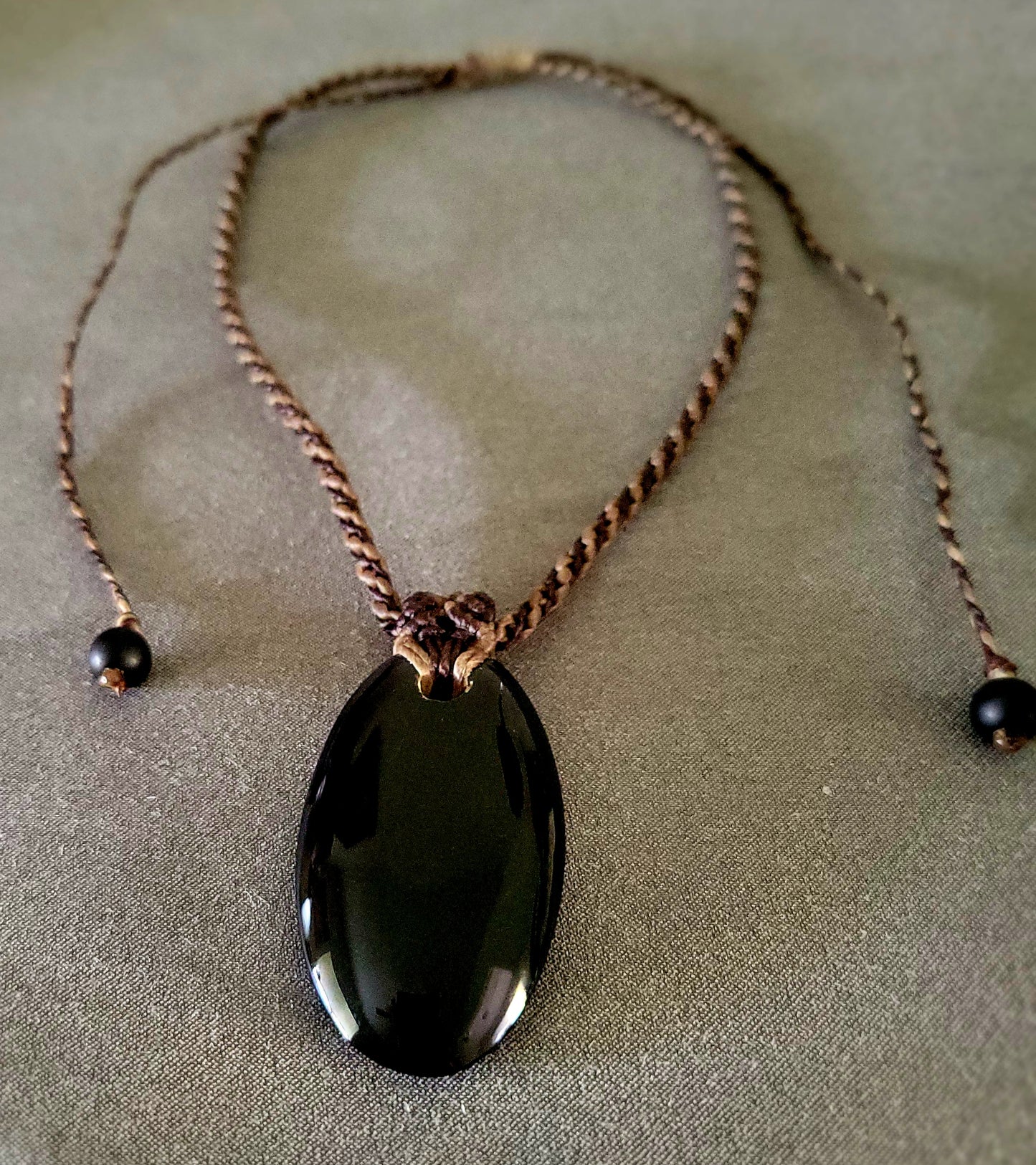 Black Onyx Necklace – Midnight Wanderer Talisman featuring a natural oval black onyx pendant on macramé cord.