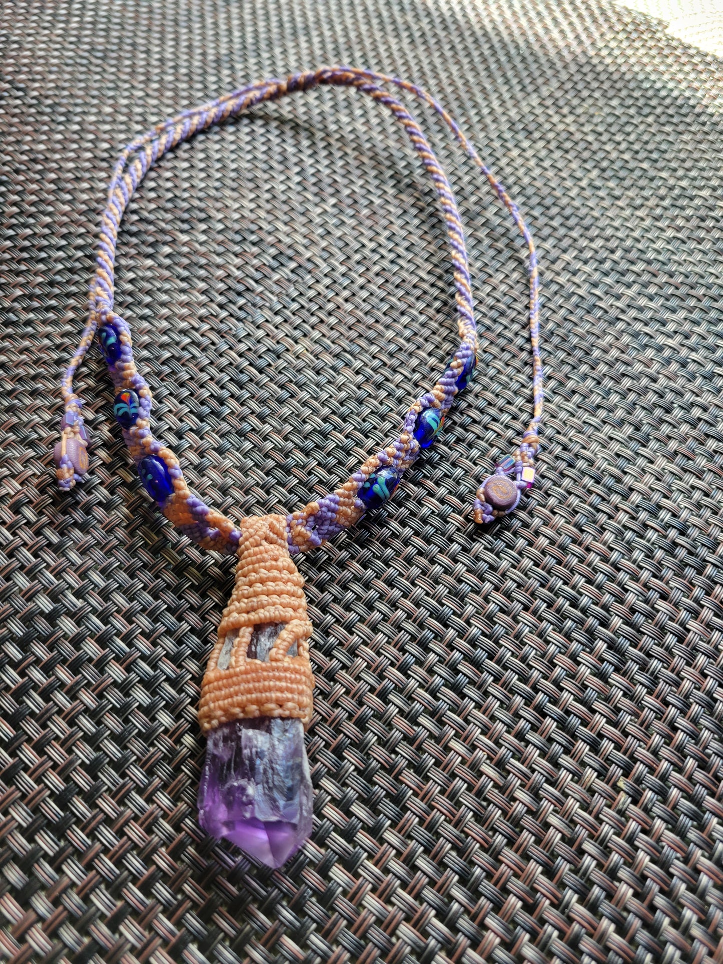 “Sacred Bloom” – Raw Amethyst Crystal Pendant Necklace, Purple & Tan Woven Cord with Blue Beads, Adjustable Feminine Jewelry