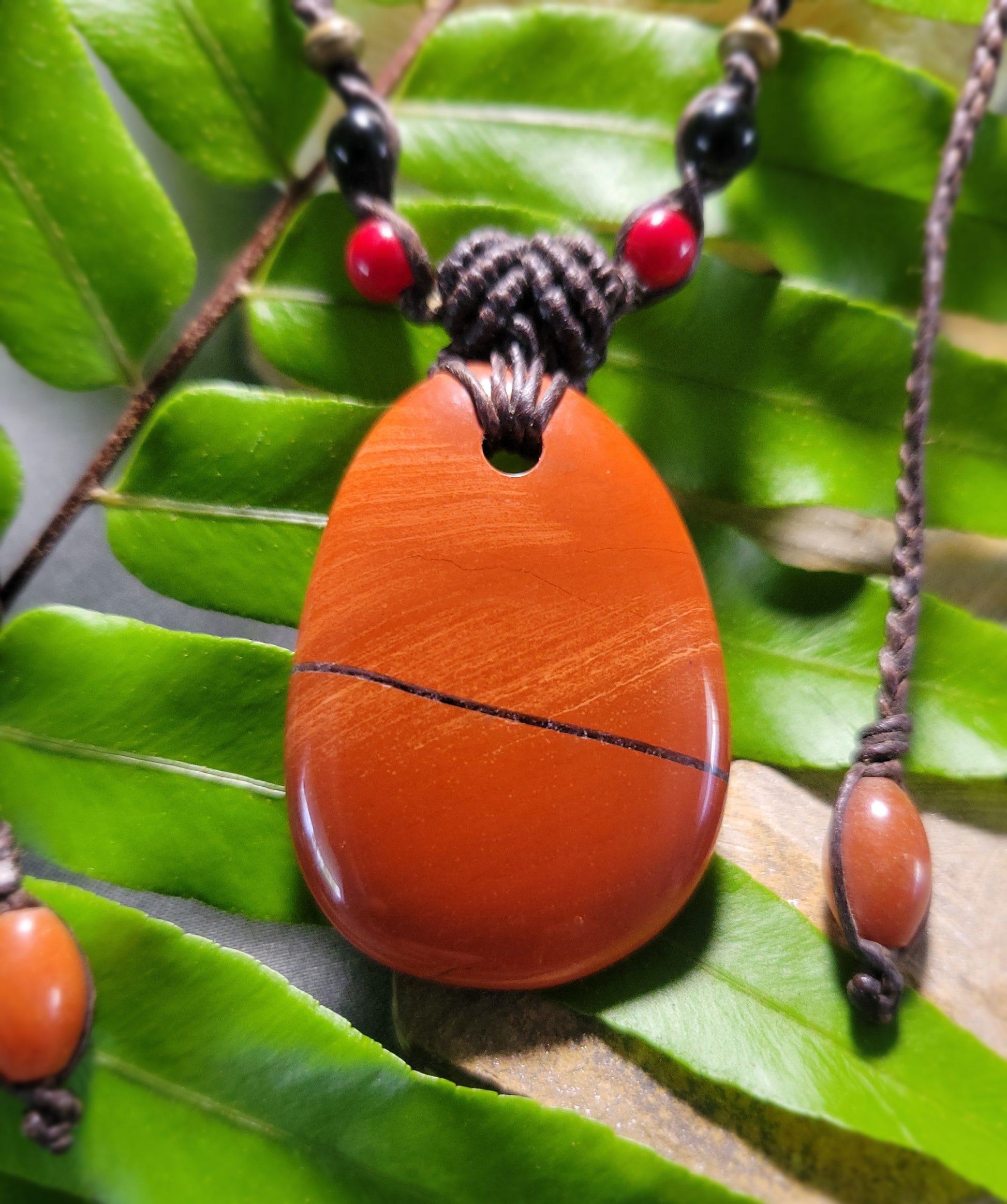 Jasper Healing Stone pendant made of natural red jasper, featuring a minimalist design and adjustable knot closure.