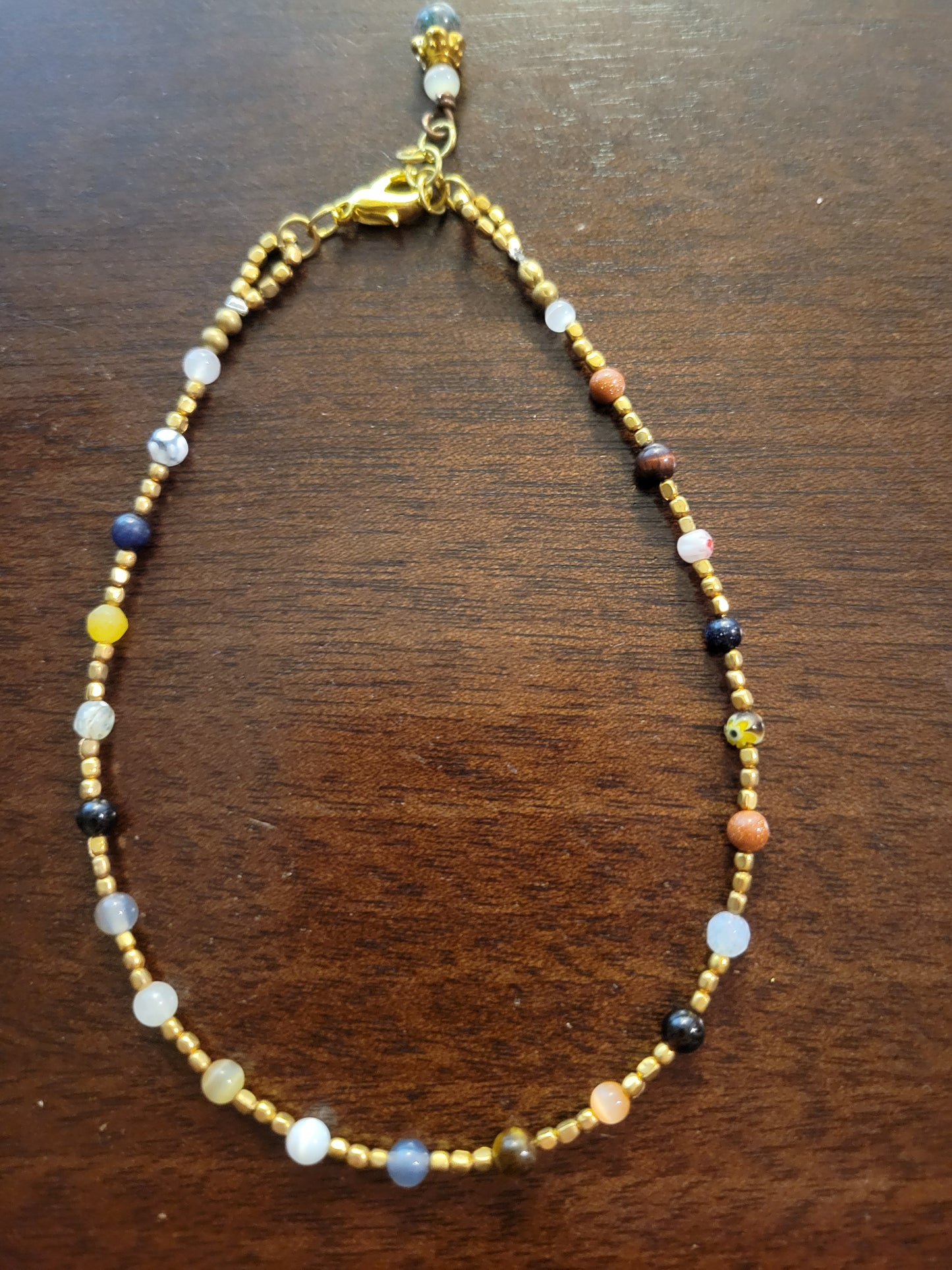 Boho Anklets – Beaded ocean charm anklets featuring colorful cat’s eye and brass beads with adjustable length.