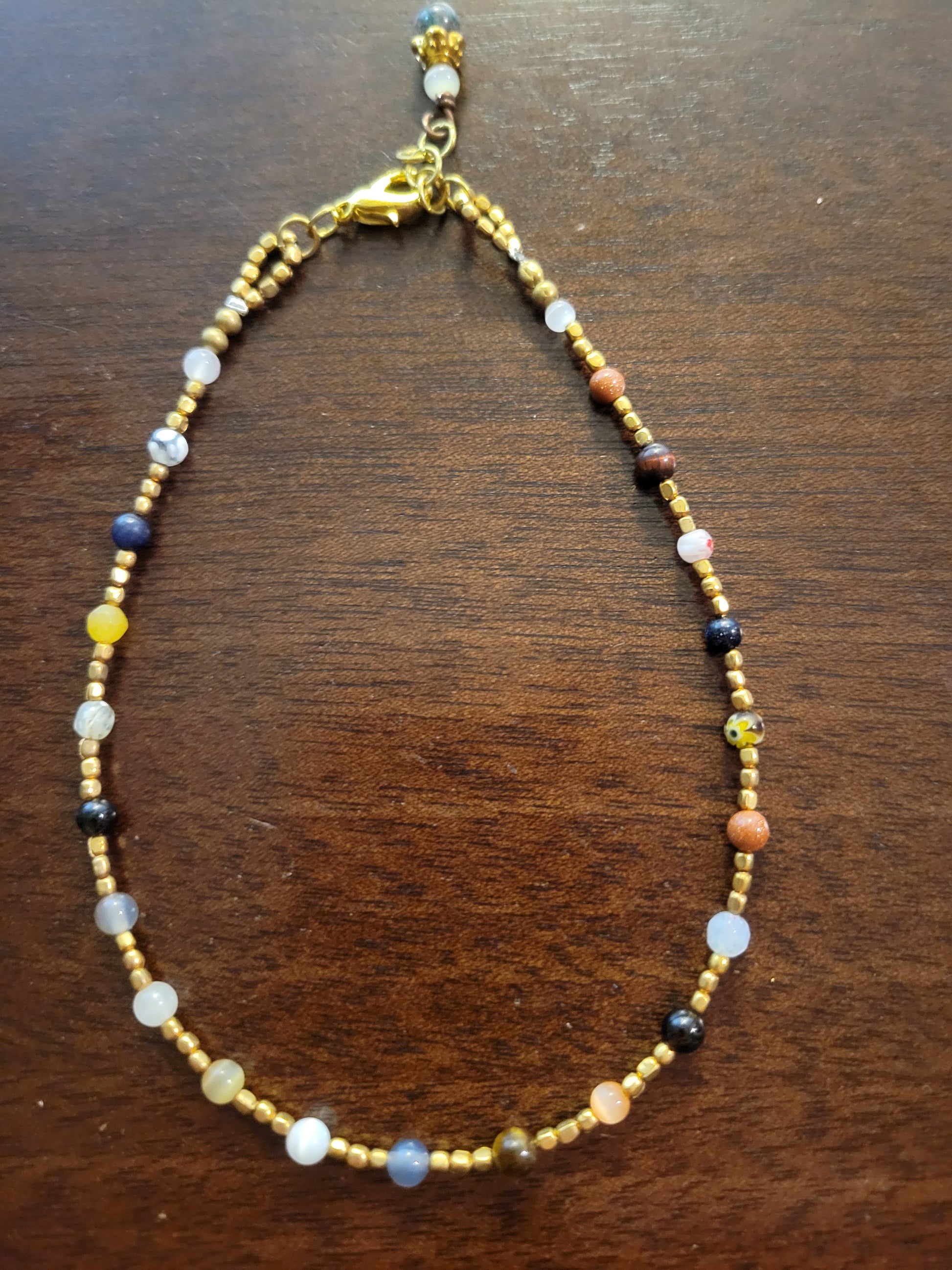 Boho Anklets – Beaded ocean charm anklets featuring colorful cat’s eye and brass beads with adjustable length.