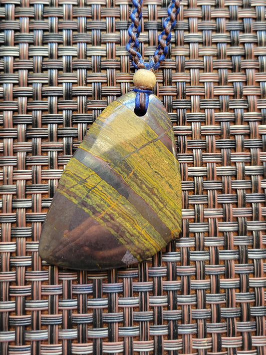 “Strength in Stillness” – Iron Tiger Eye Pendant Necklace, Blue Cord with Clear Quartz Beads, Adjustable