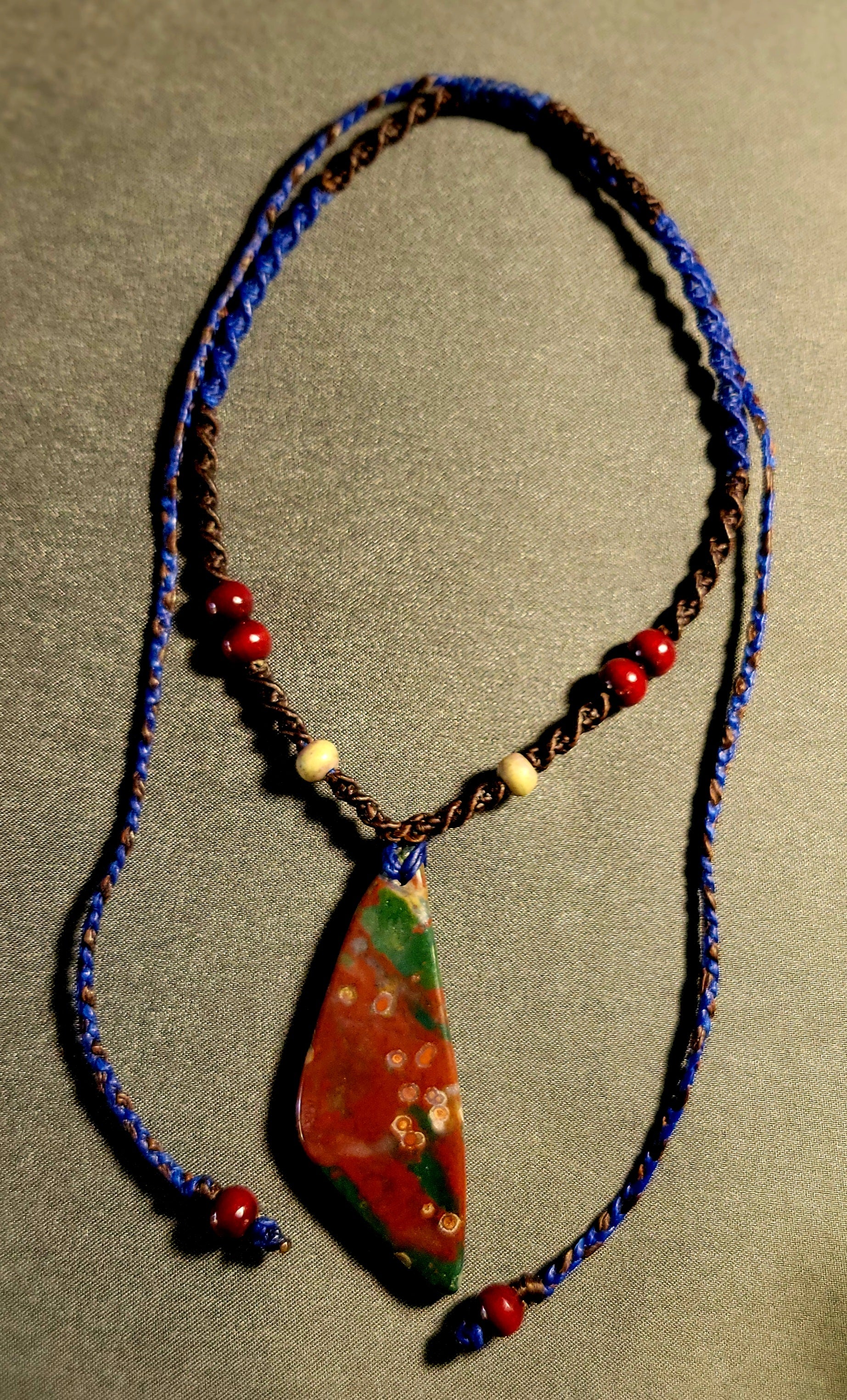 Bloodstone Pendant – The Watcher Stone on a spiral-braided macramé necklace with unique orbicular patterns.