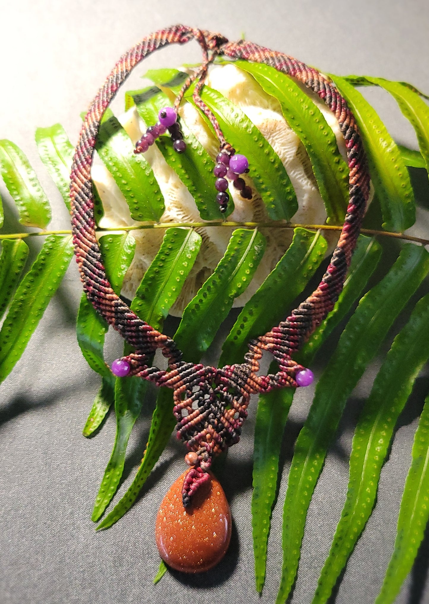 Golden Sand Stone Pendant – Desert Spirit Macramé Necklace featuring a shimmering golden sand stone and purple stone beads.