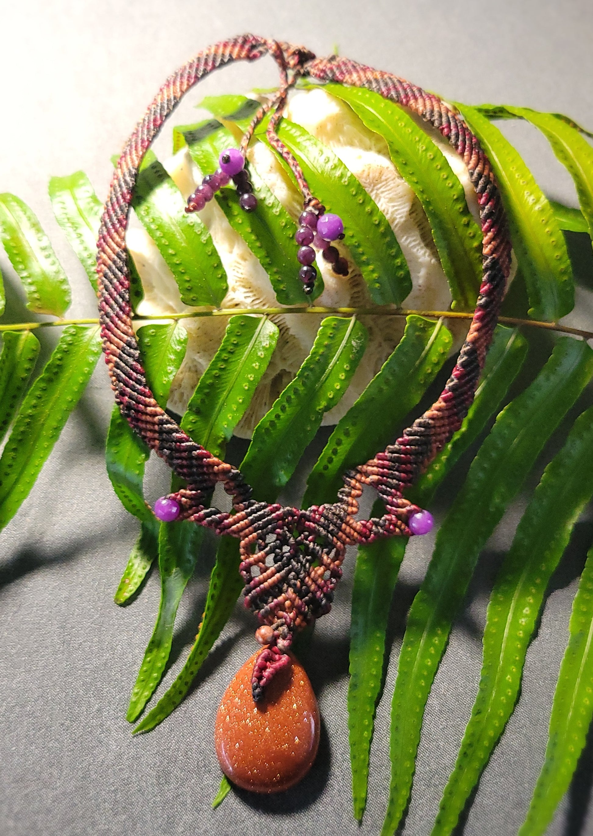 Golden Sand Stone Pendant – Desert Spirit Macramé Necklace featuring a shimmering golden sand stone and purple stone beads.