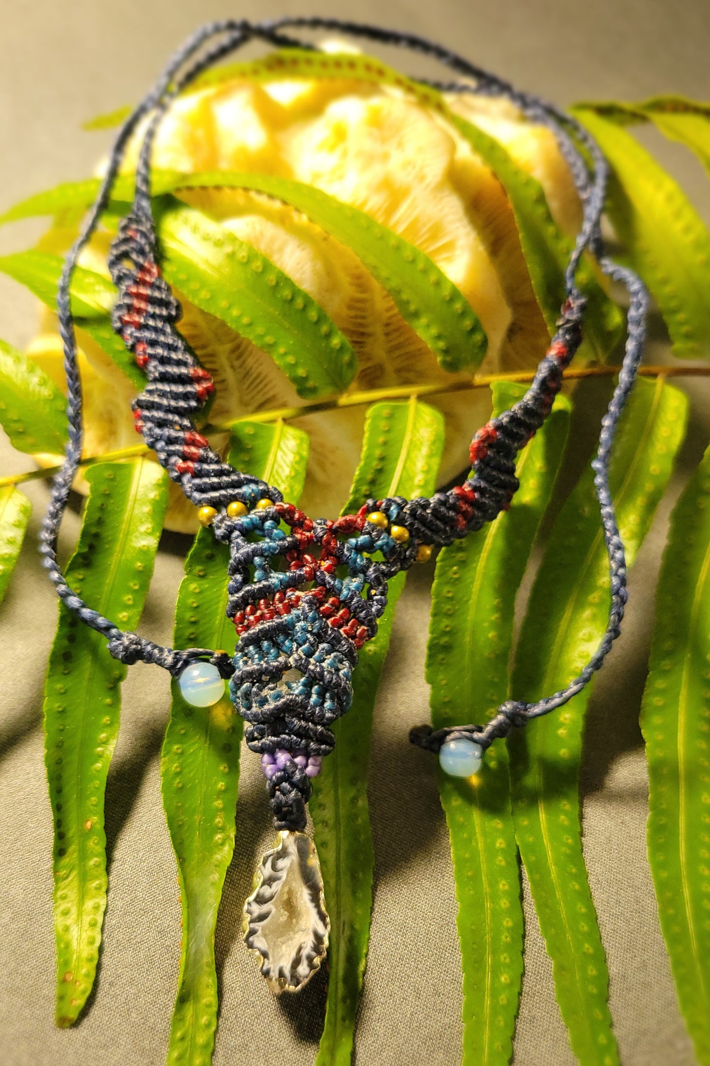 Agate Pendant Necklace featuring a handmade Y-shaped macramé design with colorful beads and an adjustable tie.