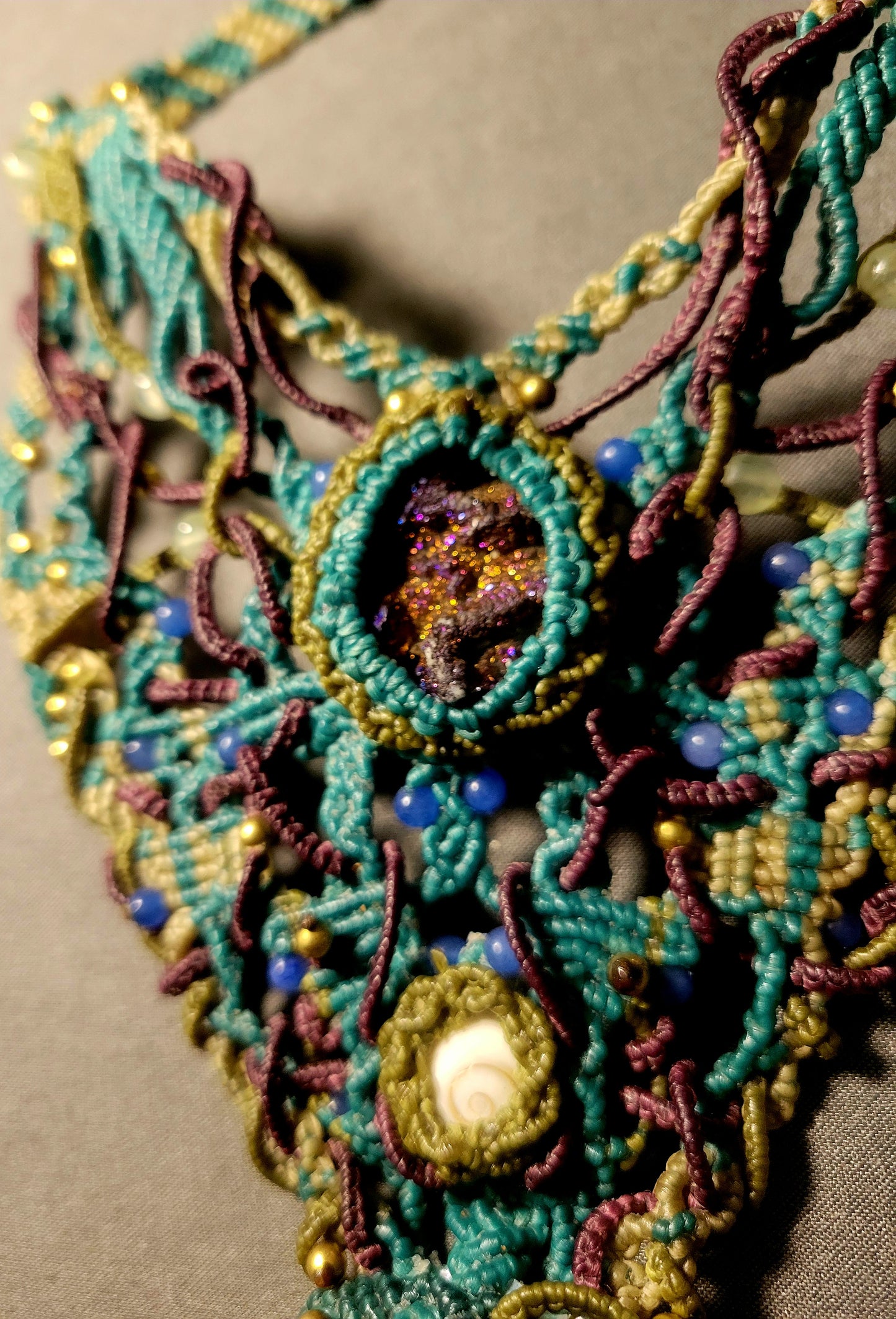 Shell Pendant featuring ornate micromacramé design and mixed stone accents in vibrant ocean-inspired colors.