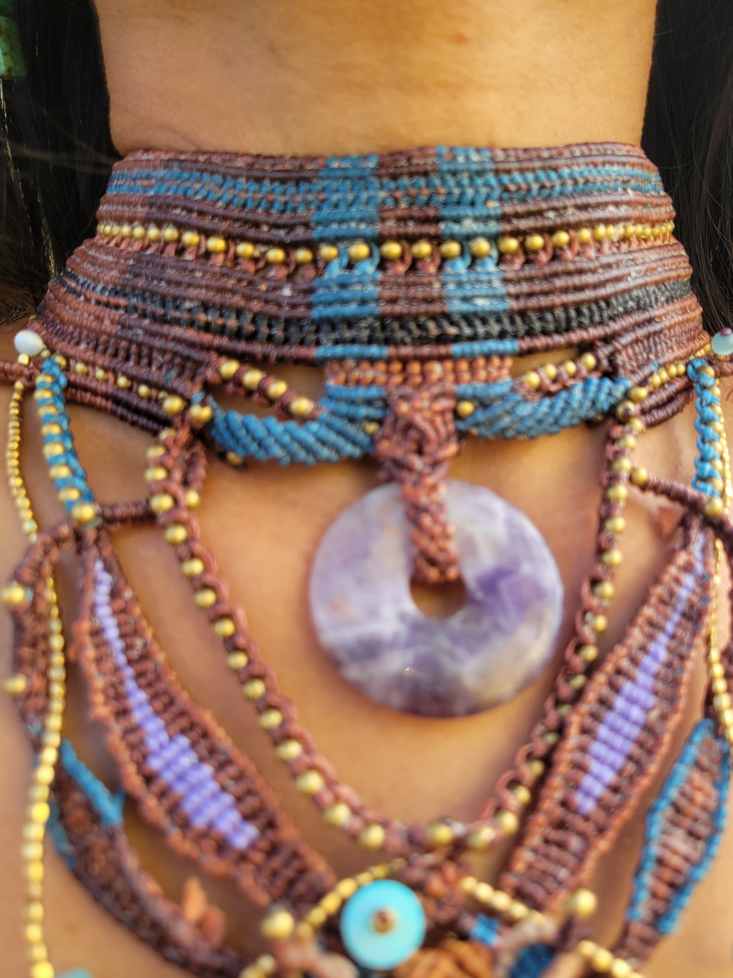 Tribal Jewelry featuring a handmade macramé collar in earth tones with a purple agate pendant and bead embellishments.