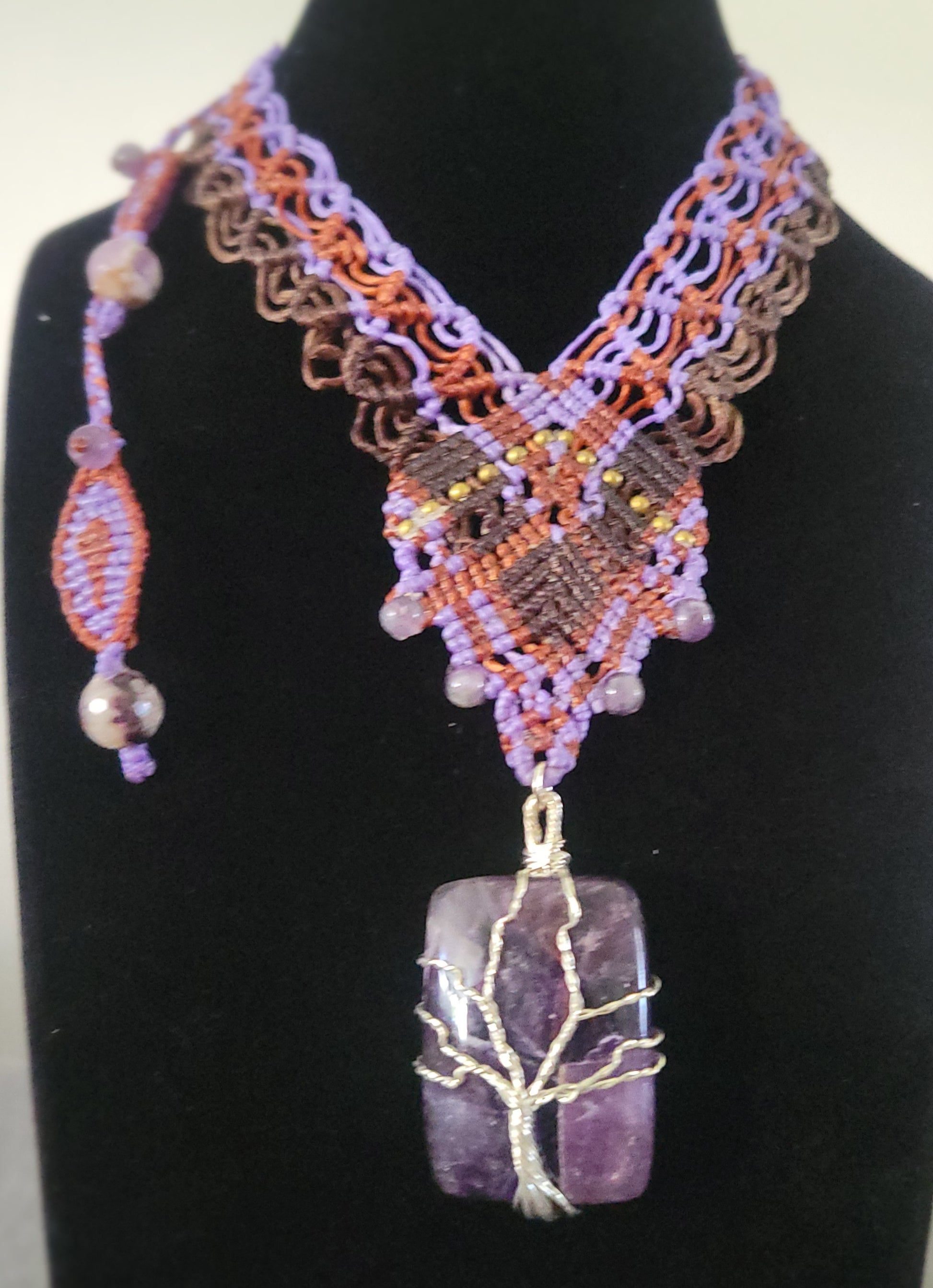 Amethyst Pendant Necklace featuring a Tree of Life design on a boho macramé choker with blue and tan accents.