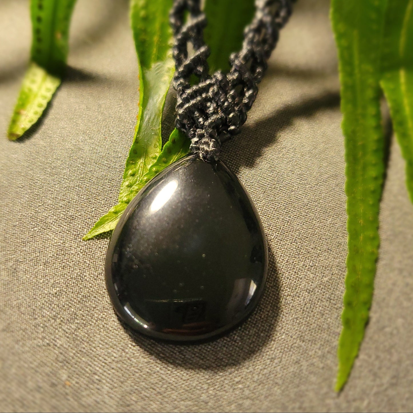 Black Jade – Boho Wave Pendant Necklace featuring a polished black jade stone on a braided macramé cord.