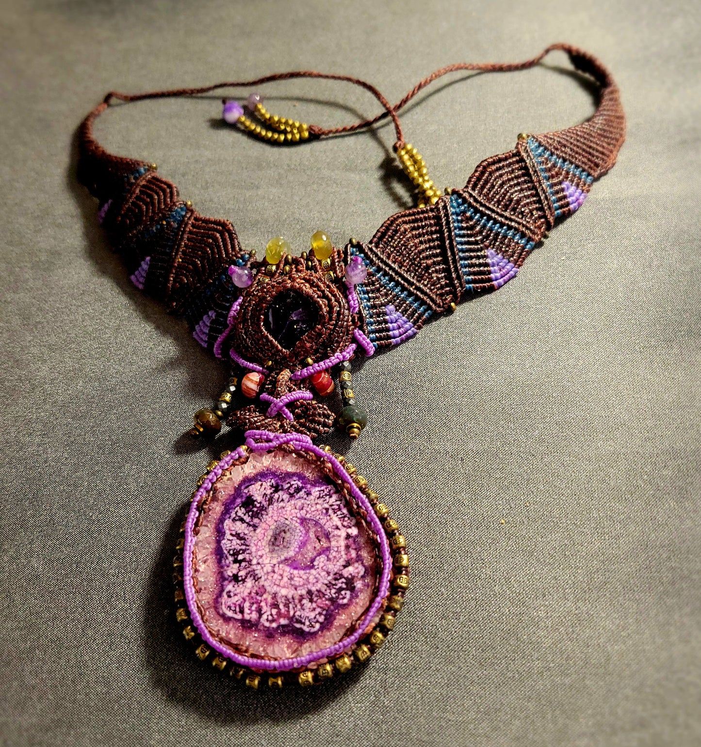 Agate Necklace – Purple stalactite slice with micromacramé choker and colorful bead accents.