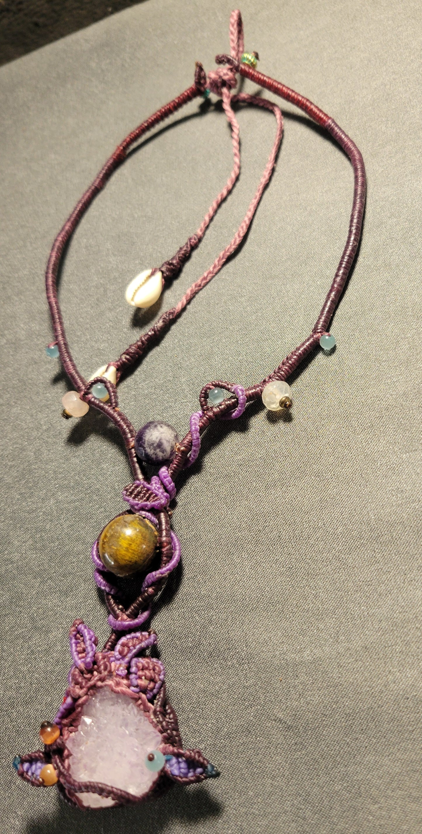 Amethyst Crystal Necklace – Dancing Energy Talisman with raw amethyst, tiger eye, and macramé design.