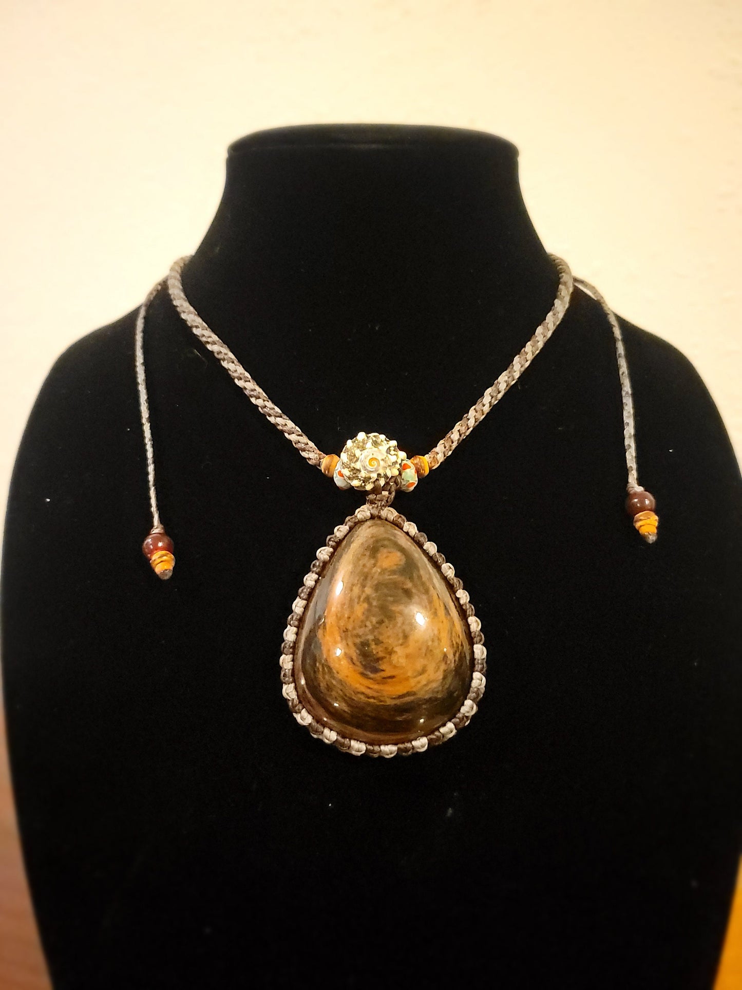 “Roots & Tides” – Mahogany Obsidian Pendant Necklace with Spiral Shell and Stone Beads, Adjustable Earth-Tone Cord